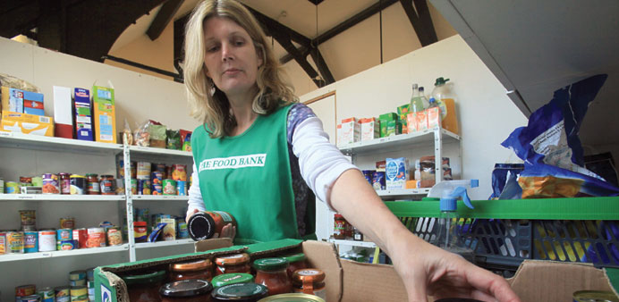 Salisbury foodbank volunteer sorts a donation of food.