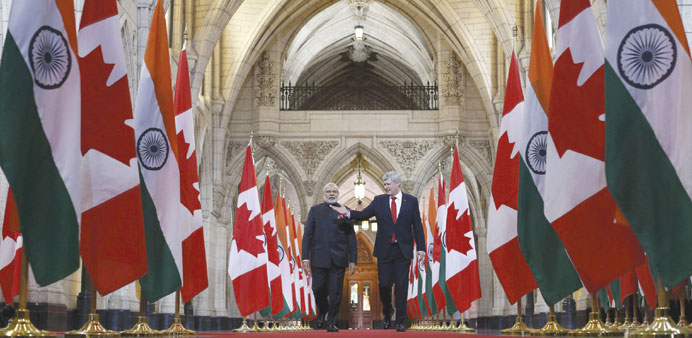 Prime Minister Narendra Modi walks in the Hall of Honour on Parliament Hill alongside Canadau2019s Prime Minister Stephen Harper in Ottawa yesterday.