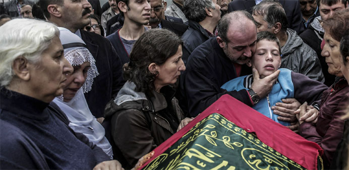 Relatives mourn near the coffin of a victim of the twin bombings in Ankara