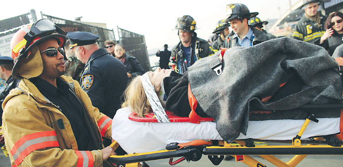 An injured woman is carried to a waiting ambulance. Nearly 60 people were injured in the accident, two of them critically