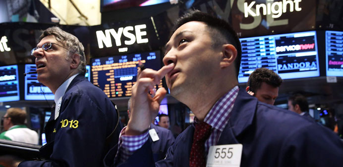 Traders work on the floor of the New York Stock Exchange yesterday. US stocks opened sharply lower yesterday after the plunge in the Japanese market s
