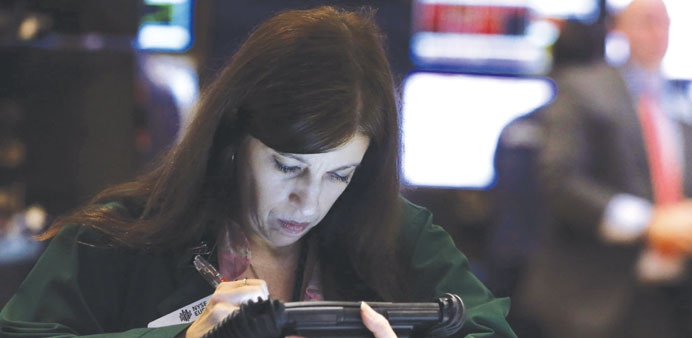 A trader works on the floor at the New York Stock Exchange yesterday. US stocks followed global markets lower, with the Dow Jones Industrial Average t