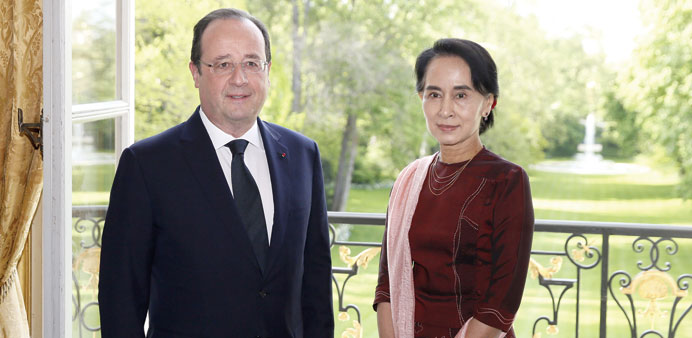 French President Francois Hollande and Myanmaru2019s opposition leader and Nobel Peace Prize laureate Aung San Suu Kyi pose at the Elysee Palace in Paris 