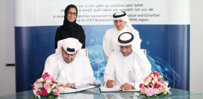Al-Kuwari of Esu2019hailSat and Balkheyour of Arabsat signing the agreement. With them are Information Minister HE Dr al-Jaber and Arabsat chairman Khasho