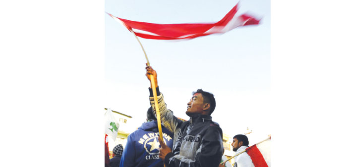 A Nepali Congress supporter waving a flag at a rally celebrating the partyu2019s election result outside of a vote counting centre in Kathmandu yesterday.