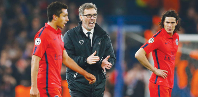 PSG coach Laurent Blanc (centre) during half time of extra time of the UEFA Champions League Second Round Second Leg in London.