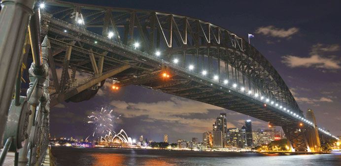 Fireworks fade as lights go out on the Sydney Harbour Bridge and Opera House to signal the start of the Earth Hour environmental campaign, among the f