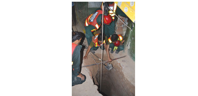 Pakistani rescue officials search for the body of Zeeshan, who was digging a 50-feet deep tunnel beneath his house in hunt for the treasure in Multan.