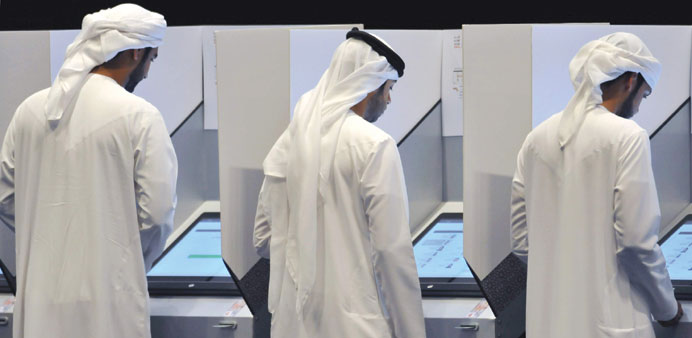 People vote at a polling station in Abu Dhabi yesterday.