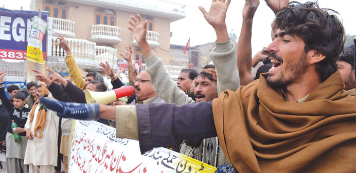 People shout slogans during a protest against an US drone attack in North-Waziristran tribal agency, in Multan, Pakistan yesterday.