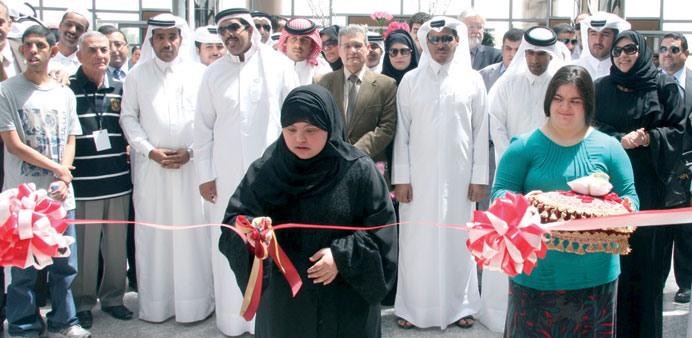 Two children of Shafallah Centre cut a ribbon to mark the formal opening of the Ezdan Mall in Gharaffa yesterday.