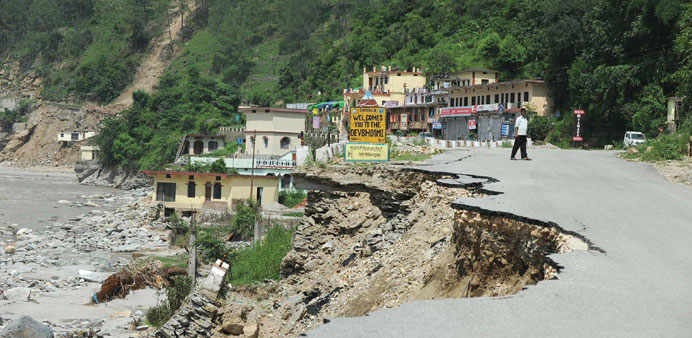 *A damaged road alongside the Mandakini river at Silli in the flood-affected area of northern Indian state of Uttarakhand.
