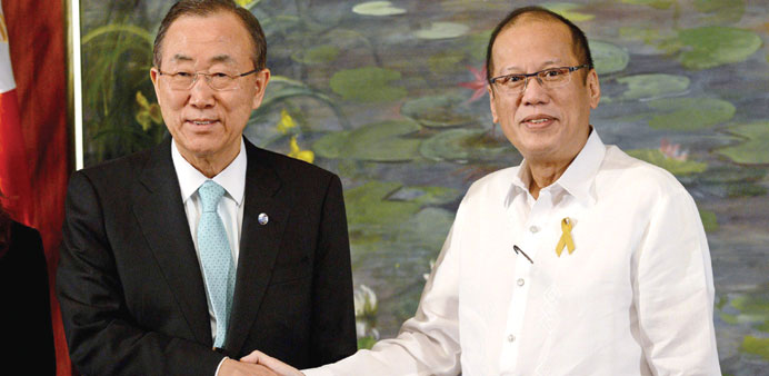 Philippine President Benigno Aquino shakes hands with United Nations Secretary-General Ban Ki-moon during a courtesy call at the Malacanang Palace in 