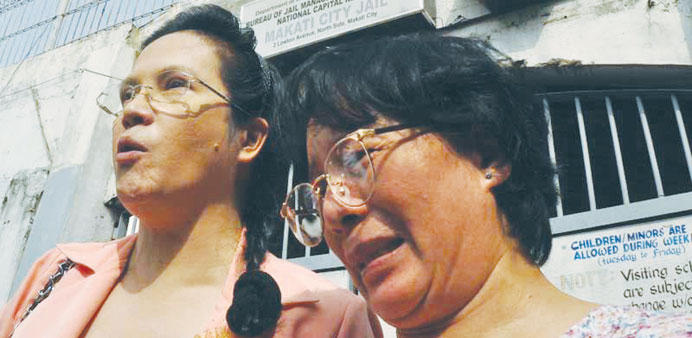 Dominga Cadelina (right), is in tears as she emerges from the Makati City jail yesterday.