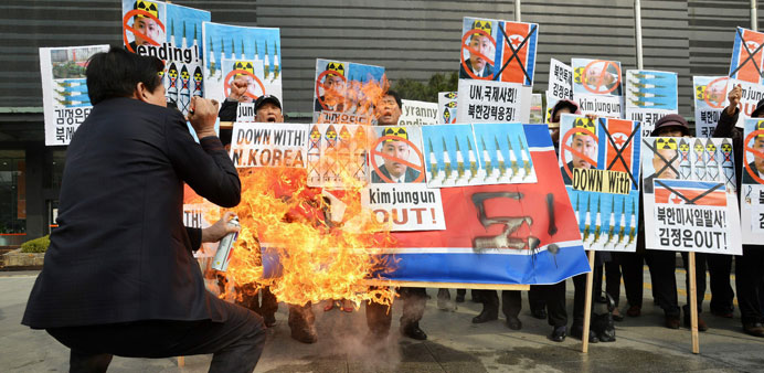 Student protesters sit under a poster reading u2018No worries Ma and Dadu2019 outside Parliament during an anti-China demonstration in Taipei yesterday.