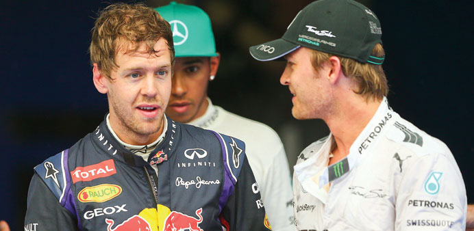 Red Bull driver Sebastian Vettel (left) and Mercedesu2019 Nico Rosberg chat after the qualifying for Malaysia Grand Prix at Sepang International Circuit. 