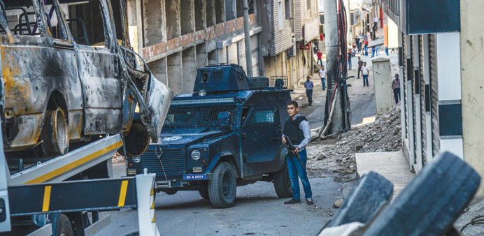 A Turkish police officer guards a street in Silvan after clashes between Turkish army and Kurdish rebels.