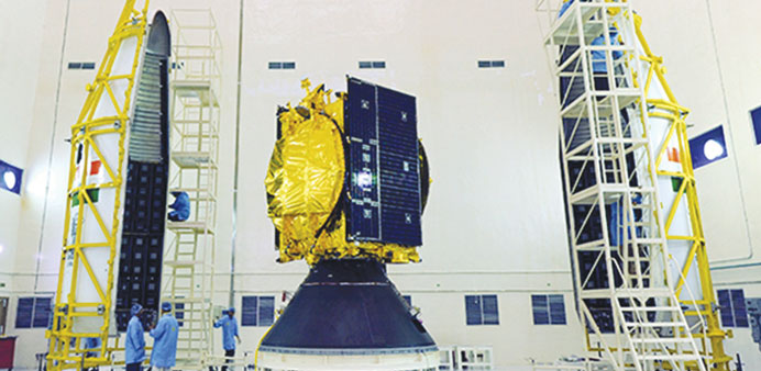 The GSAT-14 satellite (centre) is prepared for loading into its payload. The launch of the rocket carrying the satellite was called off after a fuel l