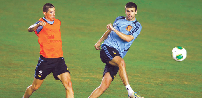 Spainu2019s Gerard Pique (right) and Fernando Torres in action during a training session in Rio de Janeiro yesterday. (Reuters)