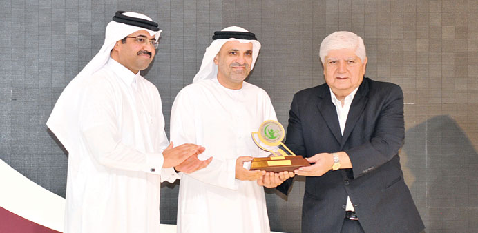 Albuainain receiving the award from HE Dr al-Sada and Dr Ibrahim.