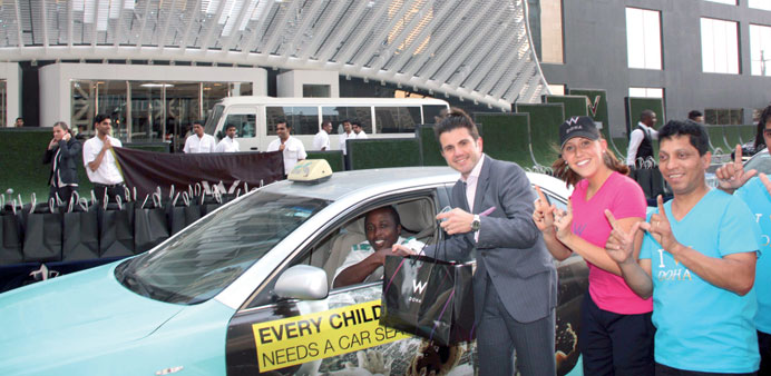 Tareq Derbas, general manager of St Regis Doha, giving an Iftar pack to a taxi driver.