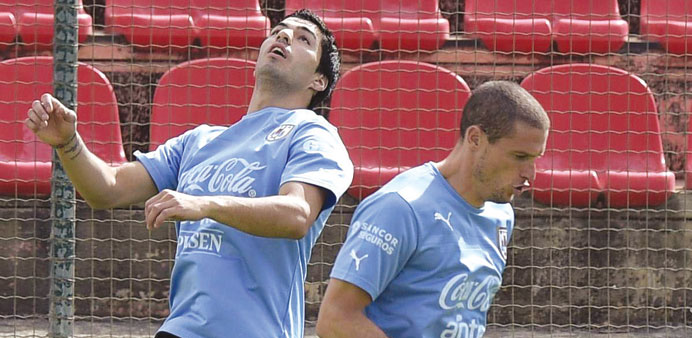 Uruguayu2019s forward Luis Suarez (left) controls the ball next to midfielder Diego Perez during a training session at Arena do Jacare in Sete Lagoas, Bra