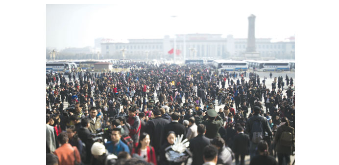 This photo taken with a tilt and shift lens shows people gathering outside at the end of the opening of the third Session of the 12th National Peopleu2019