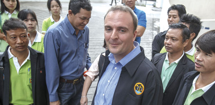 British rights activist Andy Hall is surrounded by his supporters as he arrives for his trial at the Phra Khanong Provincial Court in Bangkok yesterda