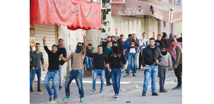 Palestinian protesters chant anti-Israel slogans during a demonstration against the closure of Shuhada street to Palestinians, in the West Bank city o