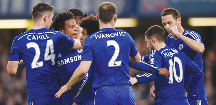 Loic Remy celebrates with teammates after scoring the second goal for Chelsea against Stoke City yesterday. (AFP)