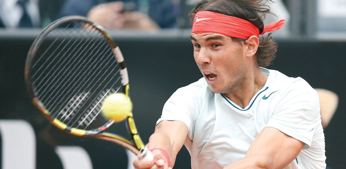 Rafael Nadal of Spain hits a return to Ernests Gulbis of Latvia during their match at the Rome Masters in Rome yesterday. (Reuters)