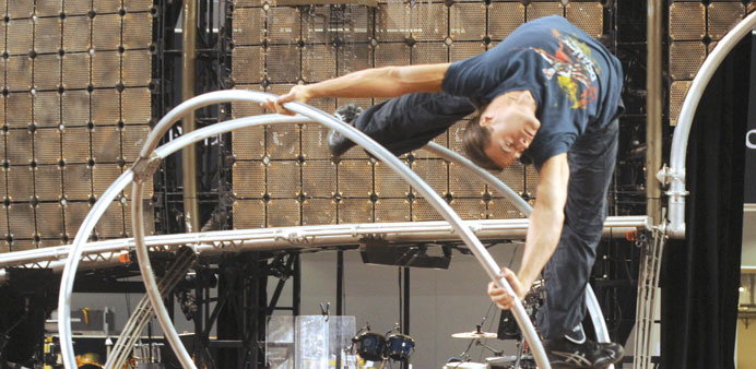 (Clockwise from above) Artists practising their acts yesterday during a rehearsal; a designer works on props and costumes for the Dralion show backsta