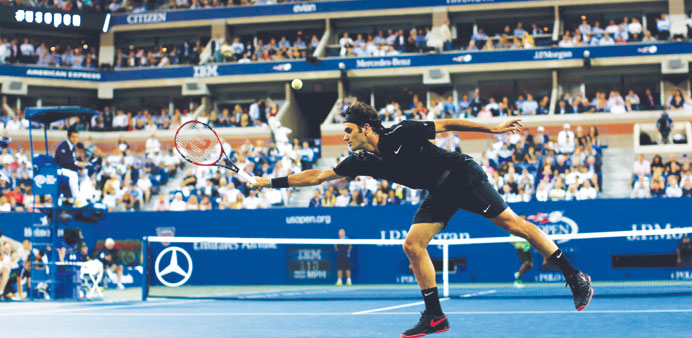 Roger Federer of Switzerland returns a shot against Gael Monfils of France during their quarter-final match at the US Open in New York on Thursday nig