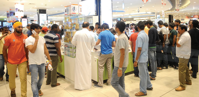 Customers throng the mobile phone section at a leading mall