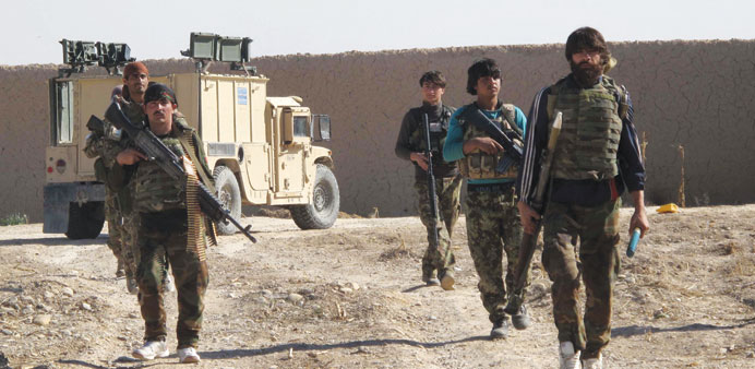 Afghan National Army (ANA) soldiers walk in Helmand yesterday. 
