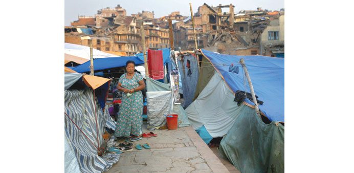 A woman stands next to tents set up after earthquakes in Bhaktapur town of Nepal yesterday.