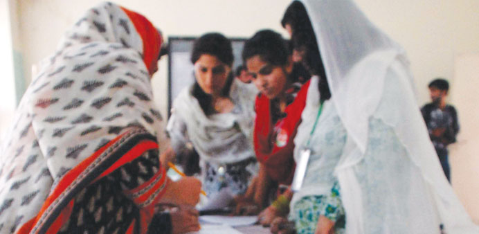  Women cast their ballots at a polling station during by-election in Islamabad yesterday.