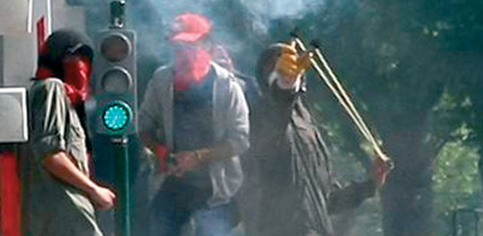 A demonstrating student uses a sling-shot in Ankara yesterday.