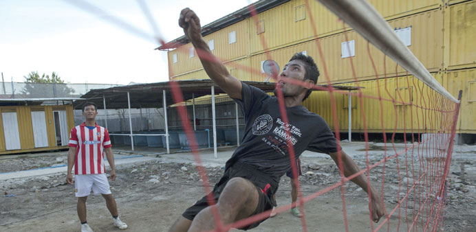Laotian worker Hussadee Sriphrajun, 30, playing the traditional Southeast Asian game of sepak takraw at a construction workersu2019 camp made of steel con