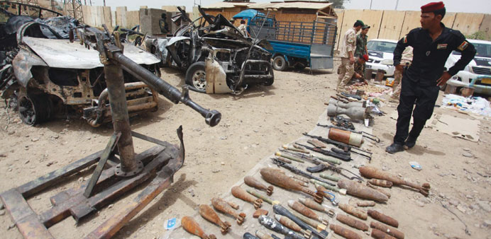 Security forces display vehicles, weapons and ammunition confiscated from the militant group Islamic State of Iraq and the Levant in Samarra yesterday
