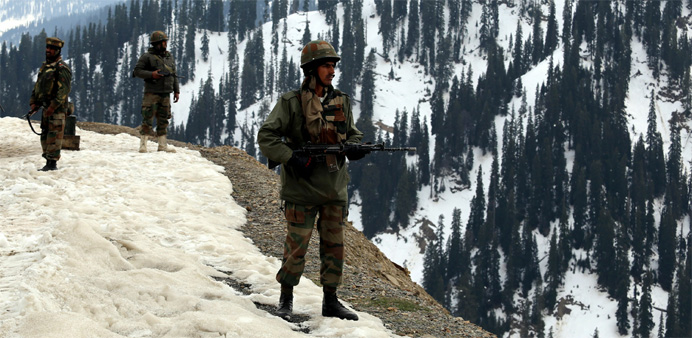 Indian army soldiers stand guard near to where an encounter took place in the Tanghdar sector north of Kashmir