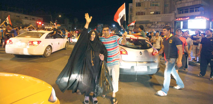 Football fans celebrate on the streets in Baghdad on Sunday.