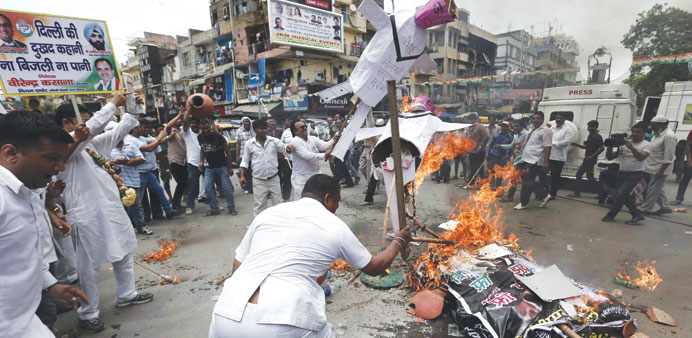 Workers of the Congress Party burn effigies representing Prime Minister Narendra Modi and Delhiu2019s former chief minister and Aam Aadmi Party (AAP) chie