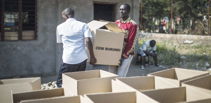 Burundians carry boxes of electoral material in the Cibitoke suburb of Bujumbura.