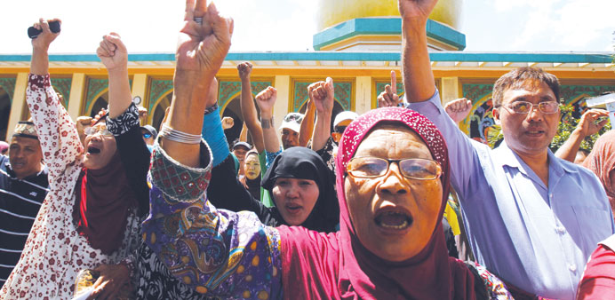Members of a Muslim group participate in a unity walk before the start of a programme to mark the upcoming signing of the final agreement between the 