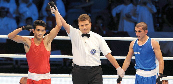  India's Shiva Thapa (left) celebrates his win over Qatar's Hakan Ersaker.