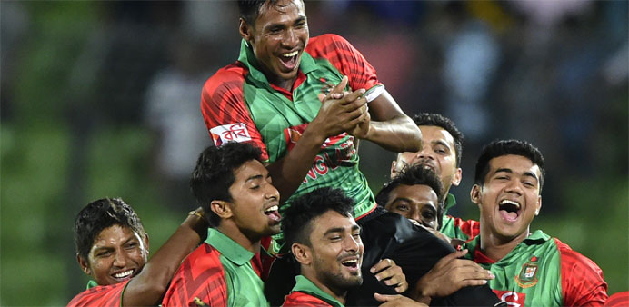 Bangladesh cricketer Mustafizur Rahman (top) is lifted by his teammates after winning the second ODI