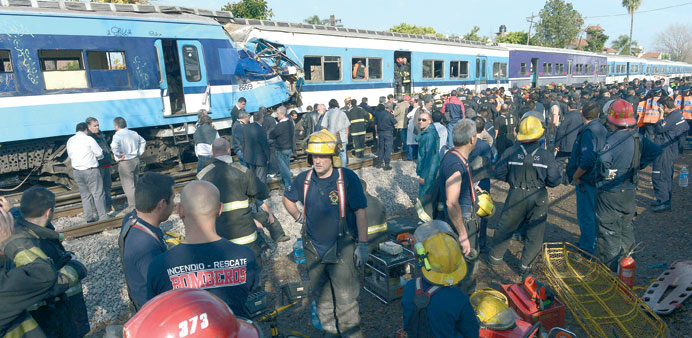 Rescue workers are seen at the site of the train crash in Castelar, some 30km west of Buenos Aires.
