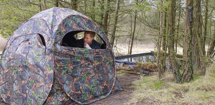 Prince Harry sits in a hide as he visits the Northumberland Wildlife Trustu2019s Red Squirrel Northern England (RSNE) project, at Frankham Woods near Four