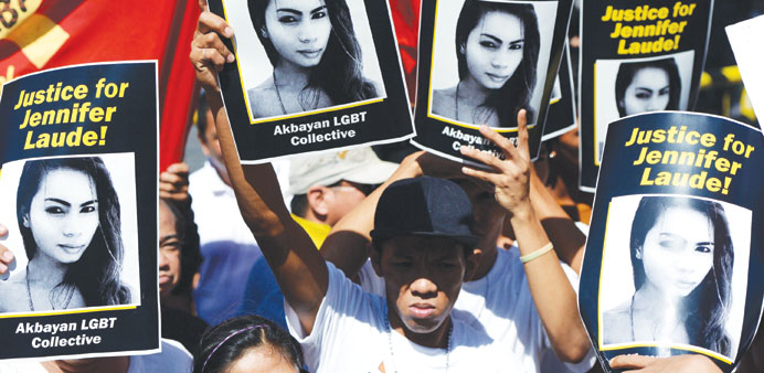 Supporters of the late Jennifer Laude hold up her image during a protest near a Philippine court in Olongapo, north of Manila yesterday.